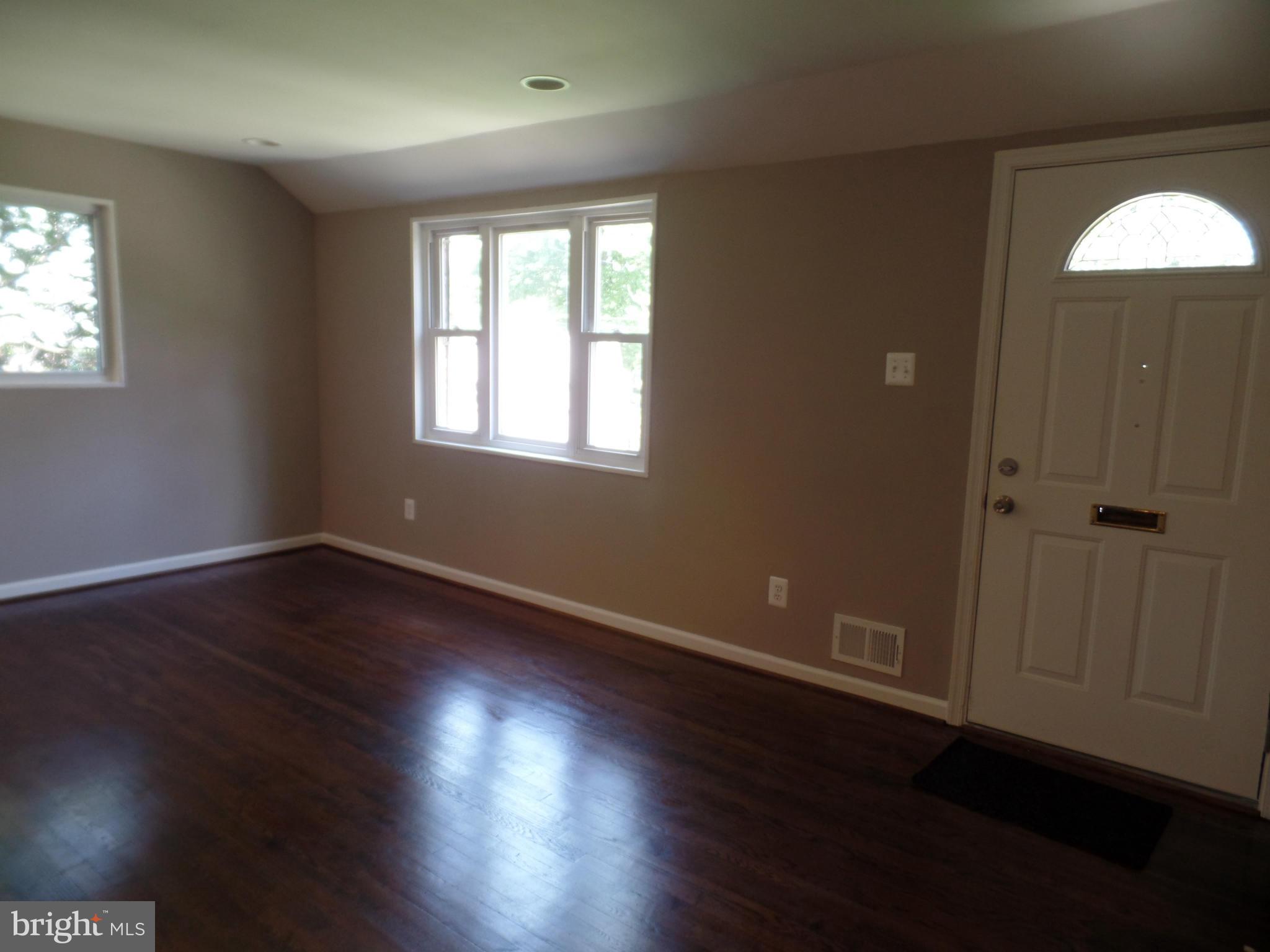 2822 Denley Place Silver Spring, MD 20906 - Photo 11 of 18 an empty room with wooden floor and windows