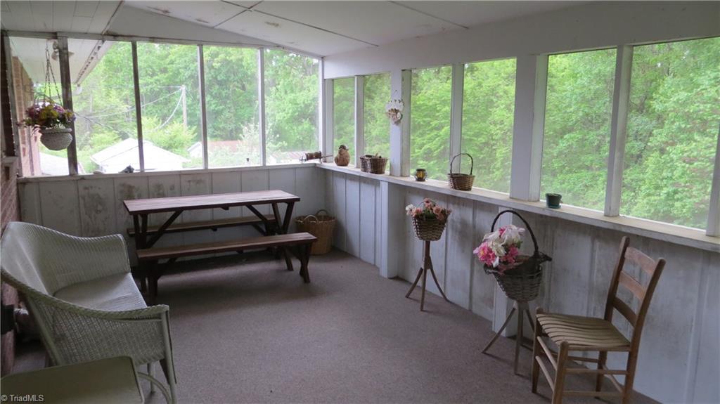 350 Doub Road Lewisville, NC 27023 - Photo 11 of 28 This space overlooks the wooded backyard. A great porch for dining or hanging socializing.