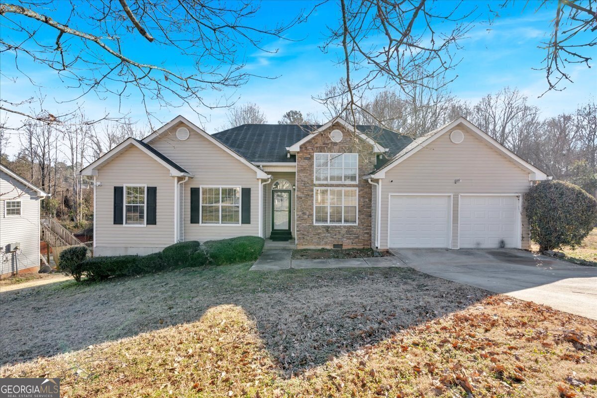 a view of a yard in front of a house with large trees