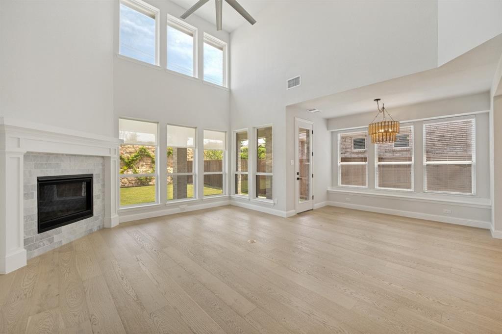1000 Adair Road Prosper, TX 75078 - Photo 1 of 37 a view of an empty room with a fireplace and a window
