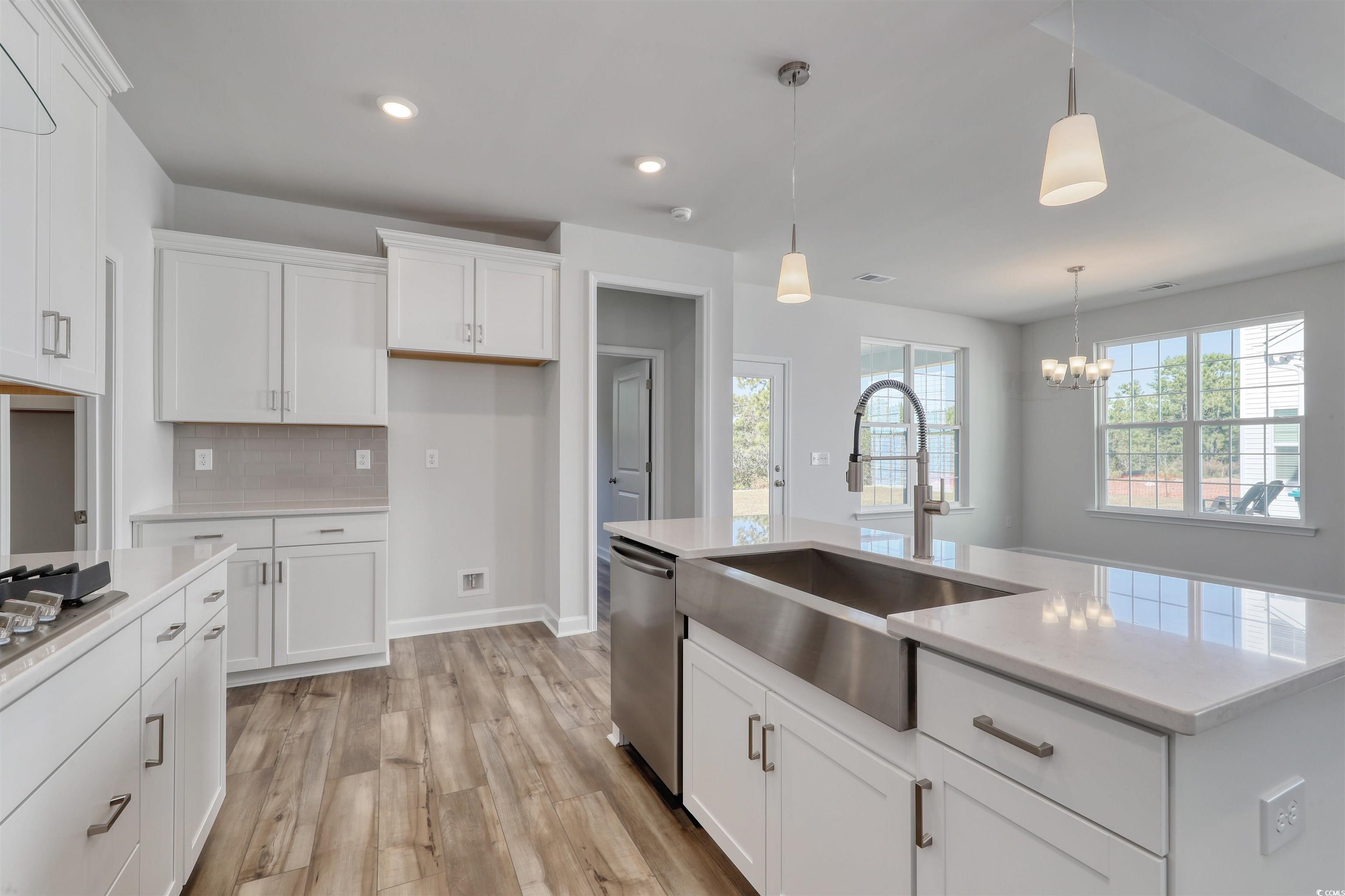 768 Enchantment Loop Myrtle Beach, SC 29588 - Photo 8 of 40 Kitchen featuring white cabinets, light hardwood /