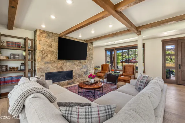 a living room with fireplace furniture and a flat screen tv
