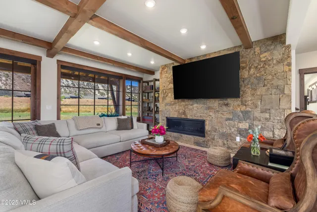 a living room with furniture flat screen tv and a fireplace