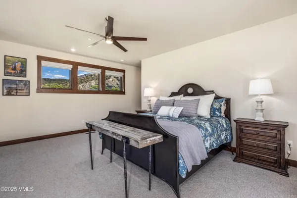 a bedroom with a bed and a painting on the wall