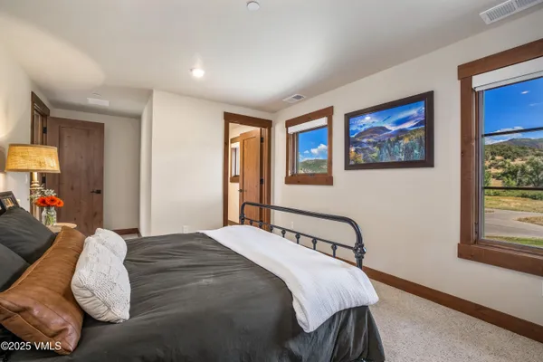 a bedroom with a bed and a painting on the wall