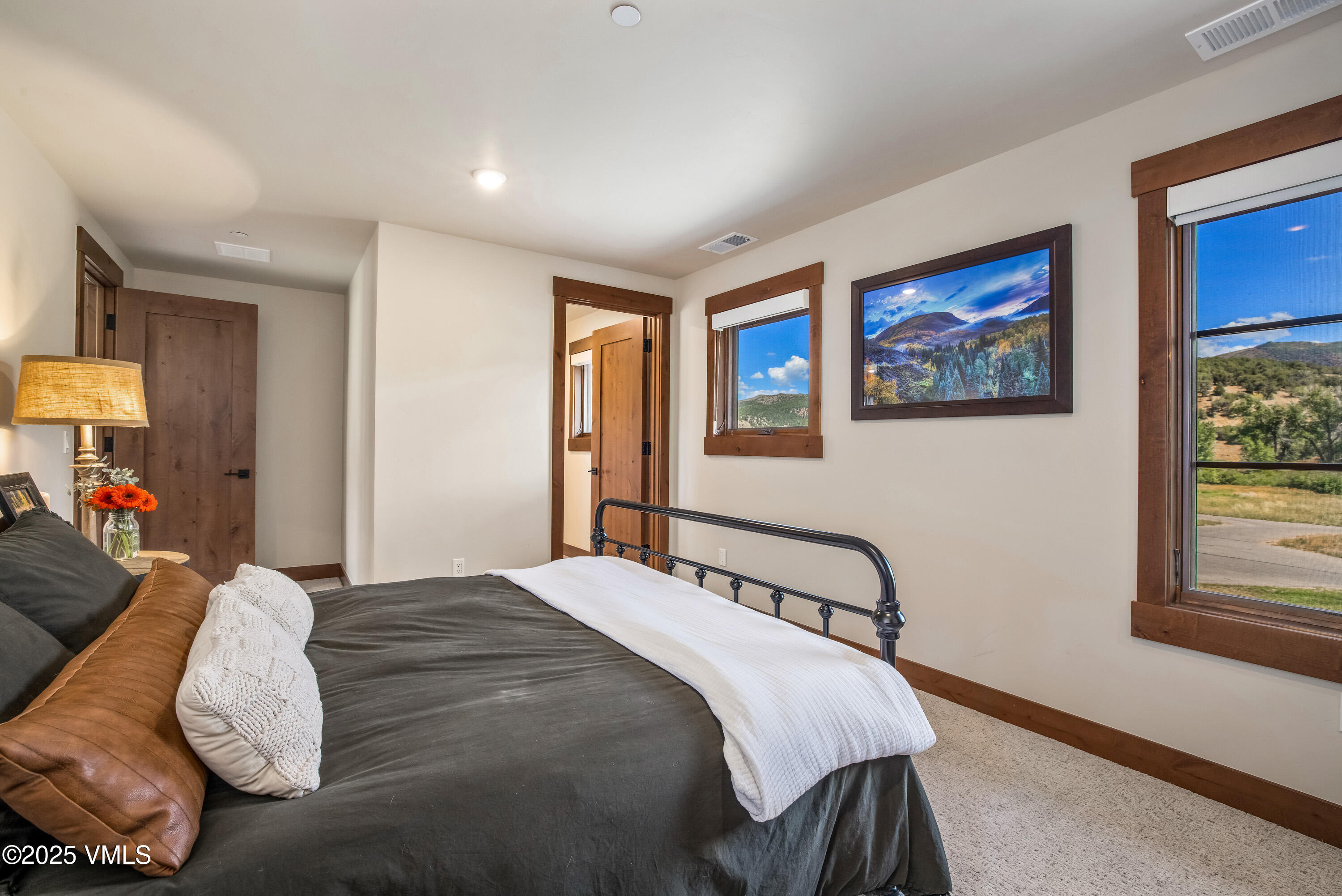 664 Hunters View Lane Eagle, CO 81631 - Photo 22 of 35 a bedroom with a bed and a painting on the wall