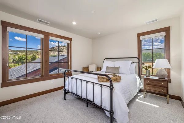 a bedroom with a bed and a large window
