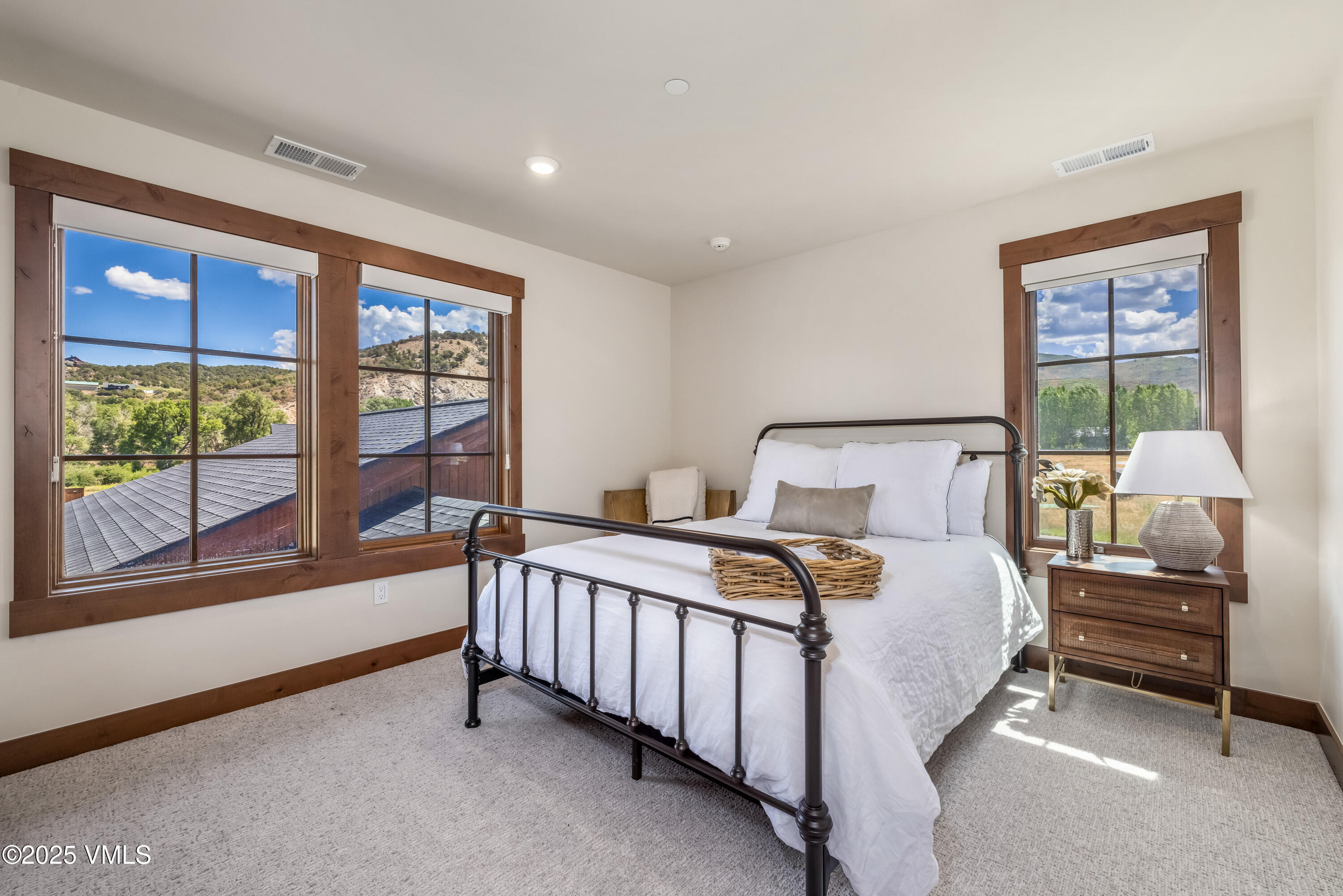 664 Hunters View Lane Eagle, CO 81631 - Photo 24 of 35 a bedroom with a bed and a large window