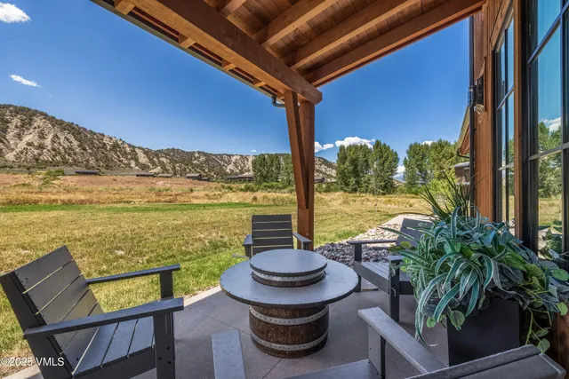 a view of a balcony with chairs and a table
