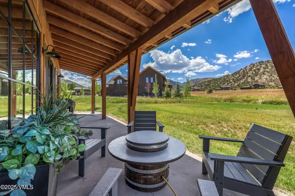 a view of a porch with furniture and a yard