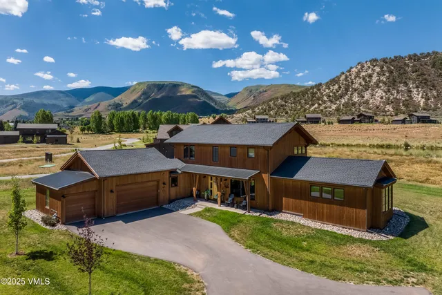 a view of a big house with a big yard