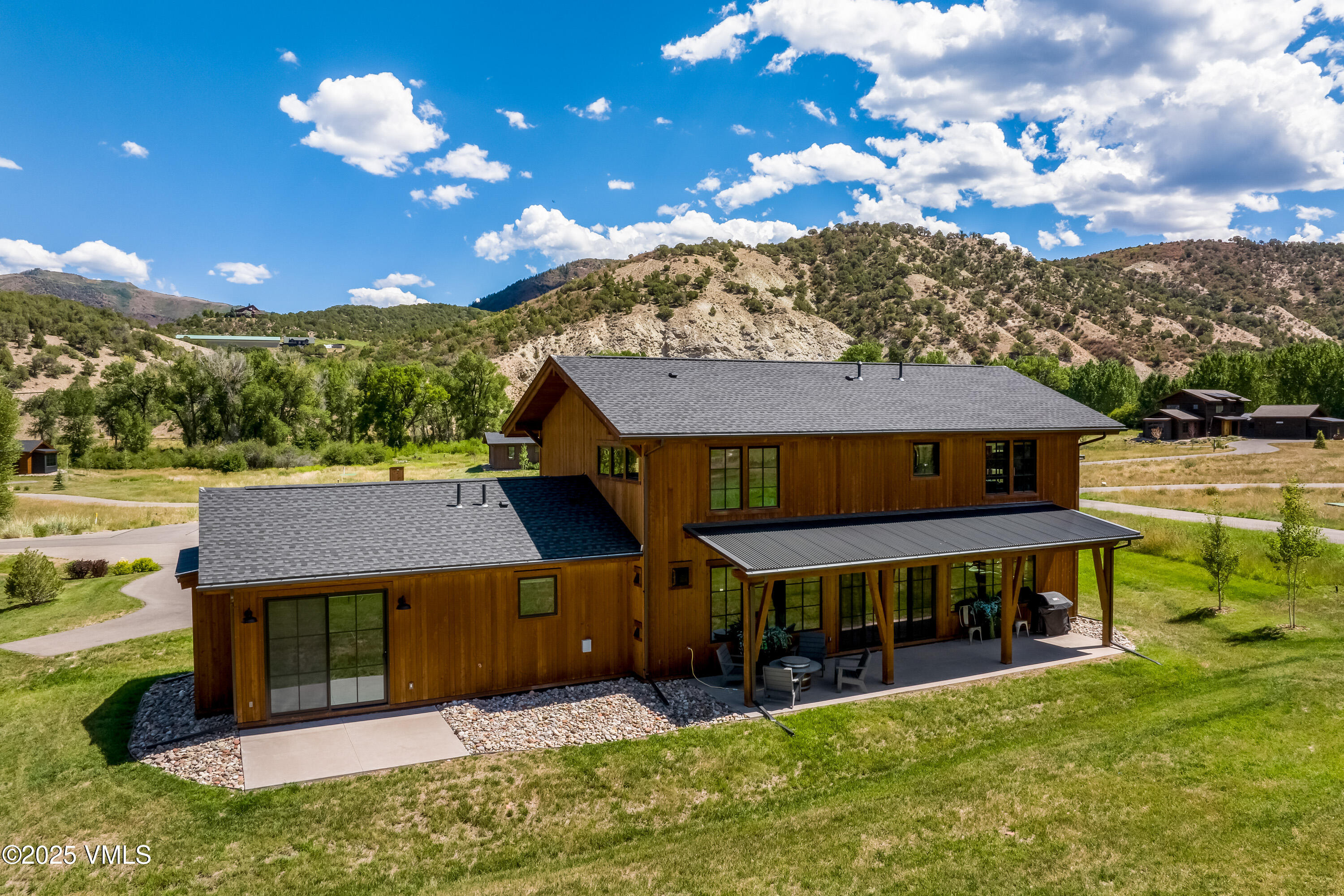 664 Hunters View Lane Eagle, CO 81631 - Photo 32 of 35 a view of a big house with a big yard potted plants and large tree
