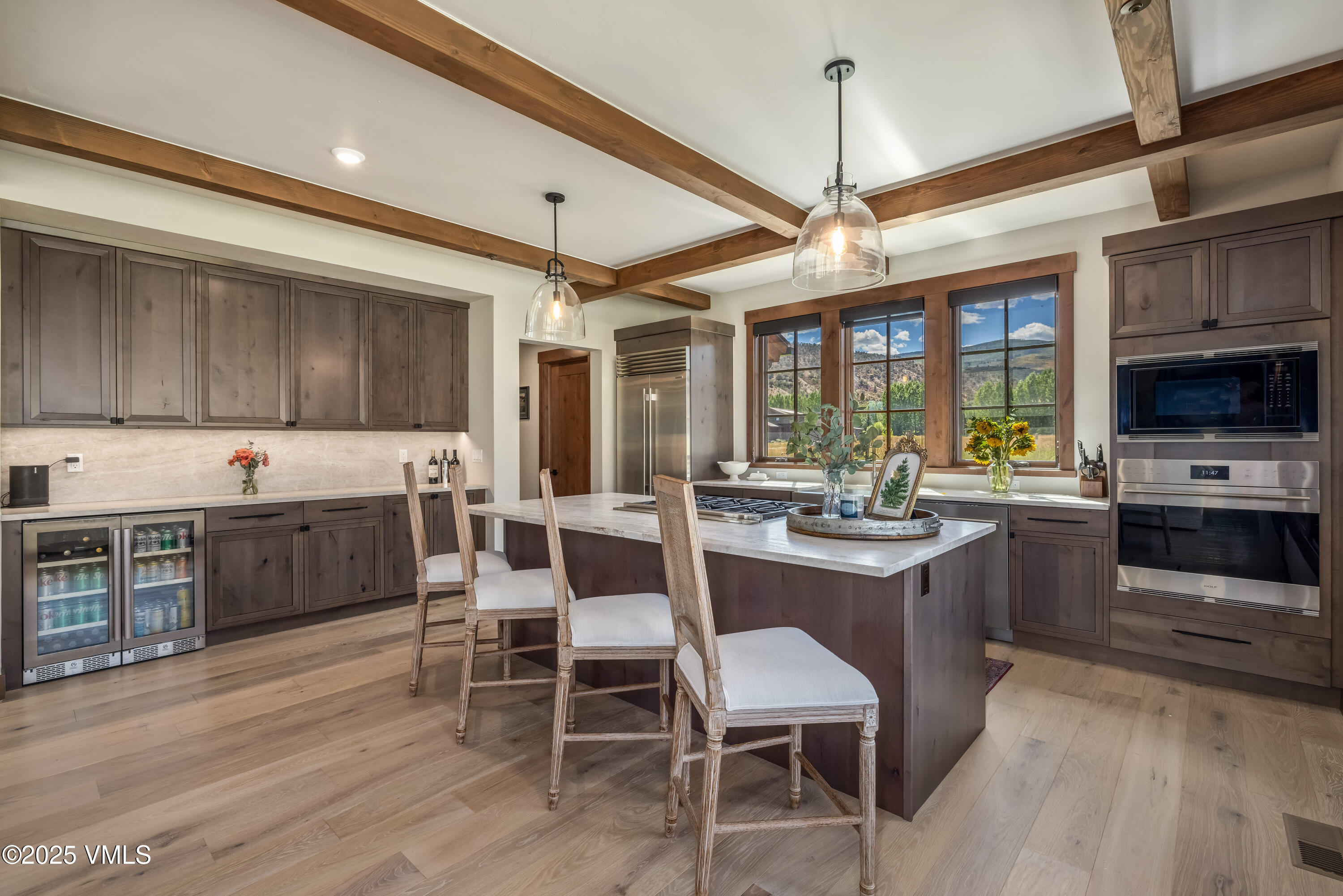 664 Hunters View Lane Eagle, CO 81631 - Photo 4 of 35 a kitchen with a table chairs stove and cabinets