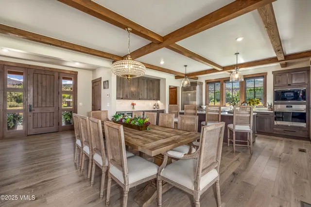a view of a dining room with furniture and wooden floor