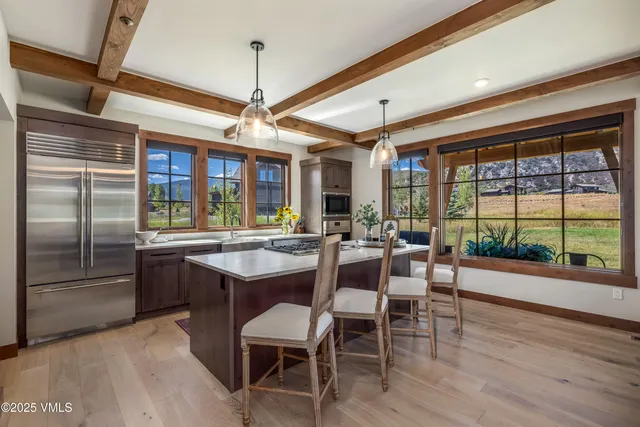 a dining area with a large window table and chairs