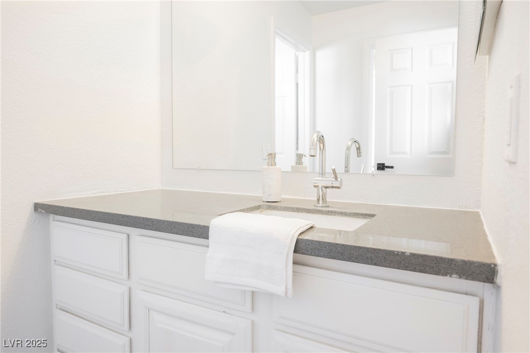1706 Toltec Circle Henderson, NV 89014 - Photo 17 of 21 Bathroom featuring vanity and a textured wall