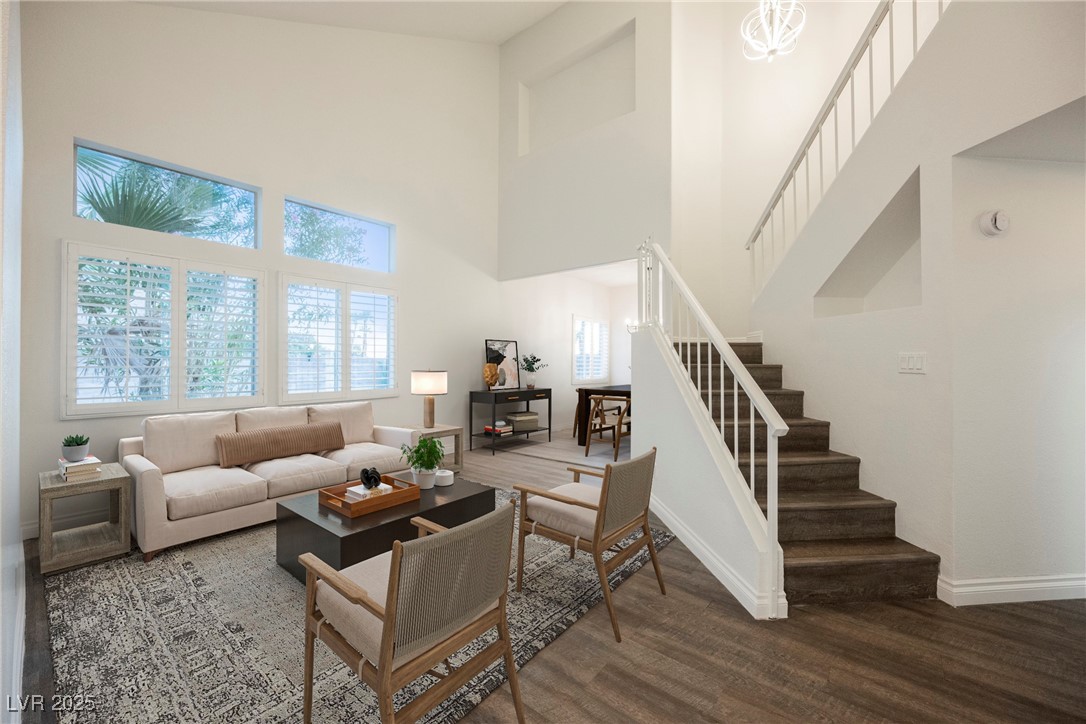 1706 Toltec Circle Henderson, NV 89014 - Photo 2 of 21 VIRTUALLY STAGED! Living area with a towering ceiling, dark wood finished floors, stairway, and a chandelier
