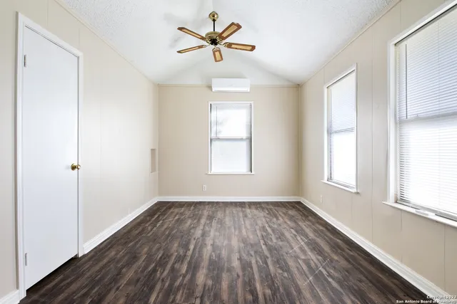 wooden floor in an empty room with a window