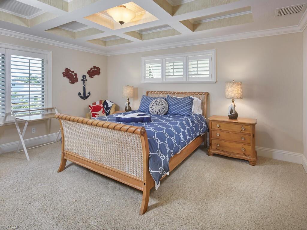 377 Pirates Bight Naples, FL 34103 - Photo 36 of 44 a bedroom with furniture and a window