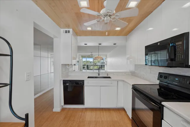 a kitchen with a sink stainless steel appliances and cabinets