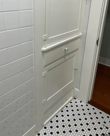 a bathroom with a black white checkered floor