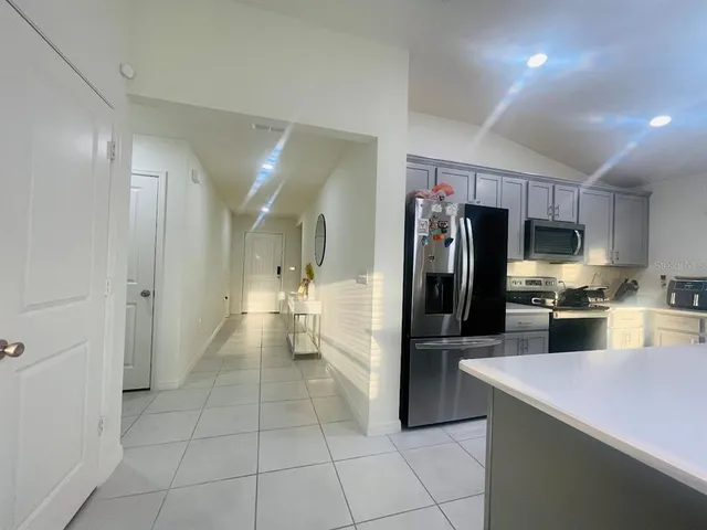 a kitchen with stainless steel appliances a refrigerator and a sink