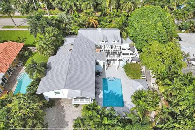 an aerial view of a house with outdoor space and street view