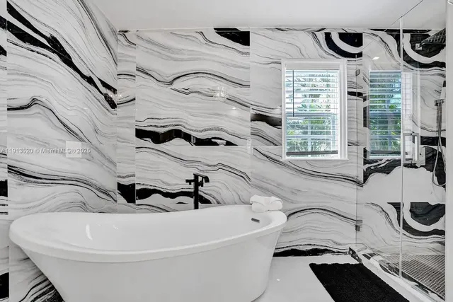 a bedroom with a bed and a large window with outer view