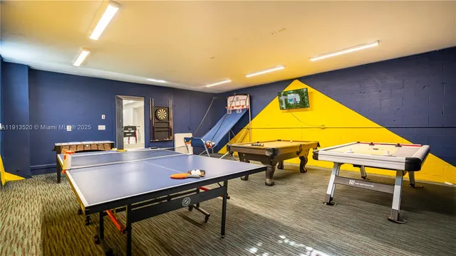 a view of a patio with table and chairs potted plants and large tree