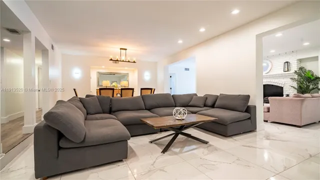 a living room with furniture and a chandelier