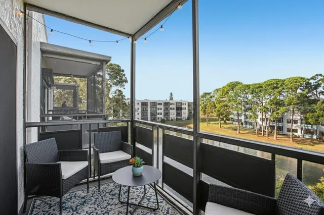 a view of a balcony with chairs and a table