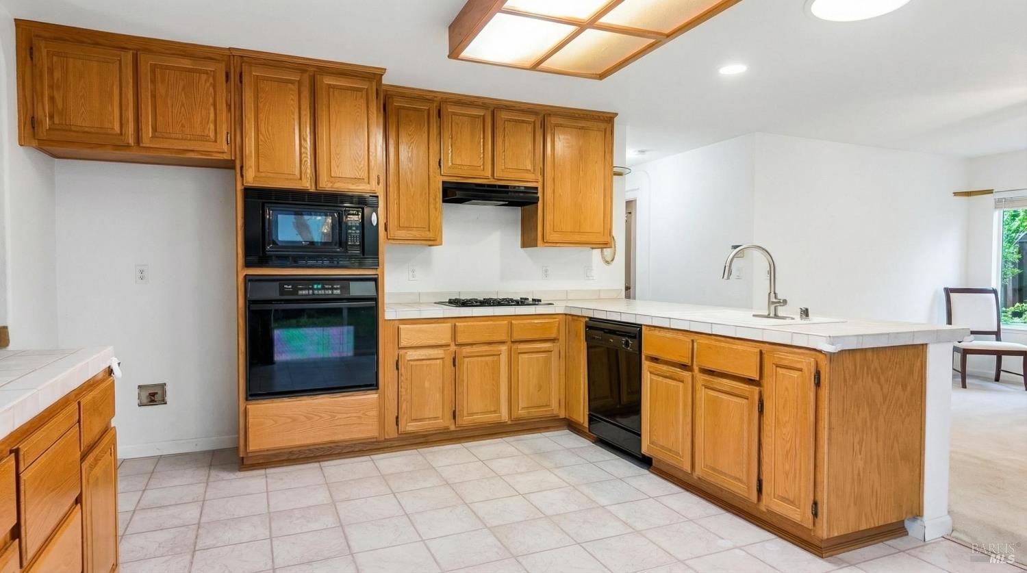 4124 Singletree Way Fairfield, CA 94533 - Photo 13 of 43 a kitchen with stainless steel appliances granite countertop a sink and cabinets