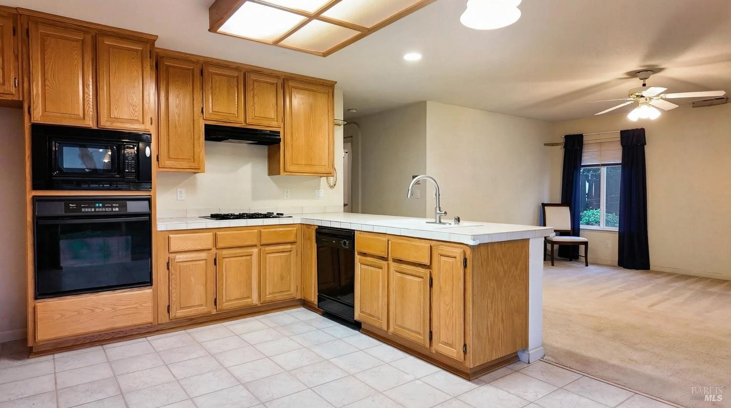 4124 Singletree Way Fairfield, CA 94533 - Photo 14 of 43 a kitchen with stainless steel appliances granite countertop a stove a sink and a microwave