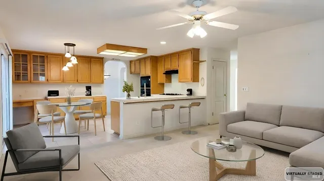 a living room with furniture a dining table and kitchen view