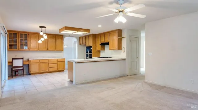 a view of a kitchen with a sink and a refrigerator