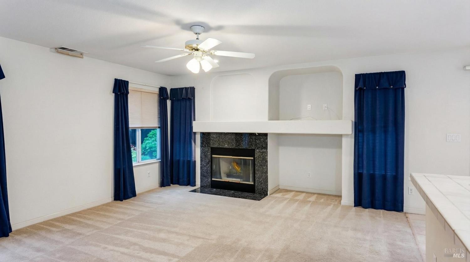 4124 Singletree Way Fairfield, CA 94533 - Photo 18 of 43 a view of an empty room with fireplace and a window
