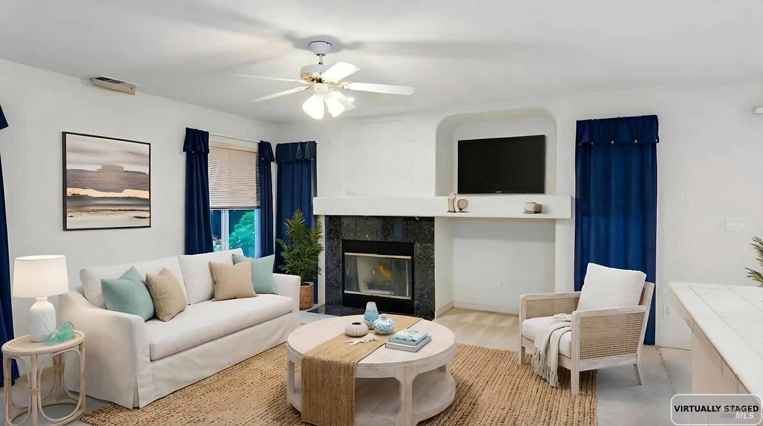 4124 Singletree Way Fairfield, CA 94533 - Photo 20 of 43 a living room with furniture a fireplace and a flat screen tv