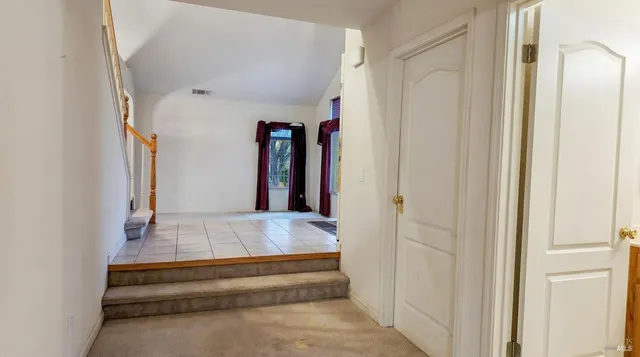 a bedroom with a bed and a large mirror