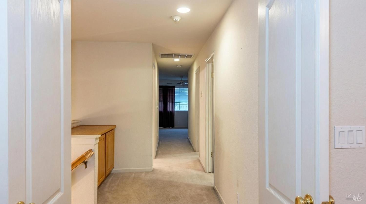 4124 Singletree Way Fairfield, CA 94533 - Photo 26 of 43 a view of a hallway with wooden shelves