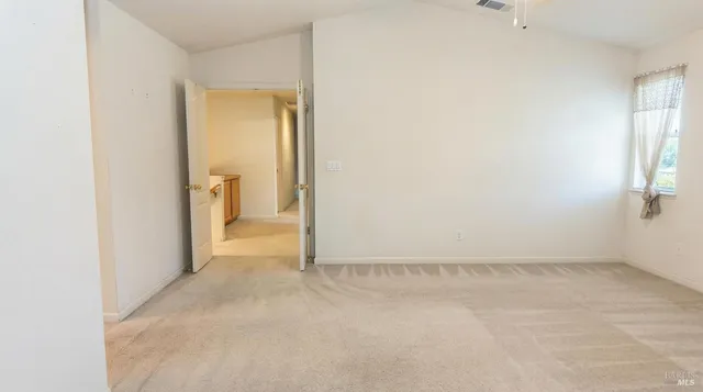 an empty room with windows and closet