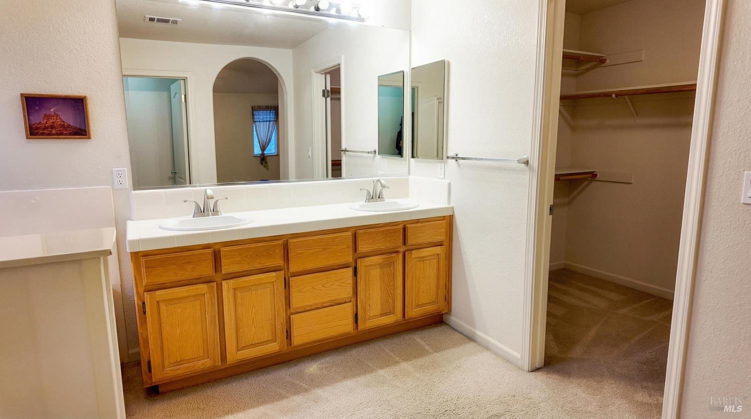 4124 Singletree Way Fairfield, CA 94533 - Photo 31 of 43 a bathroom with a double vanity sink and a mirror