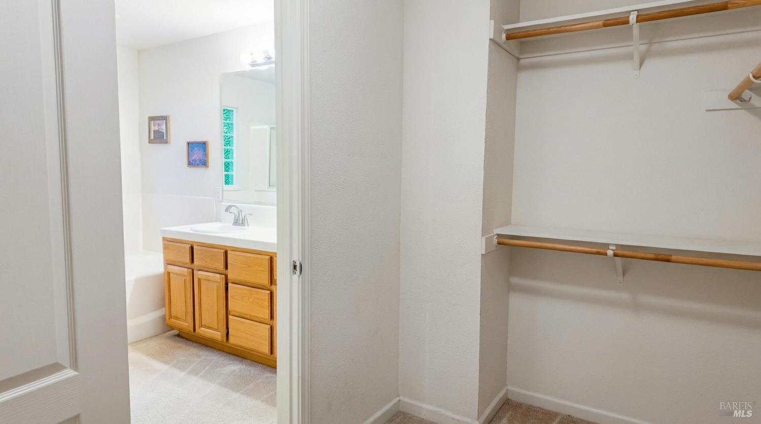4124 Singletree Way Fairfield, CA 94533 - Photo 32 of 43 a view of walk in closet with empty racks
