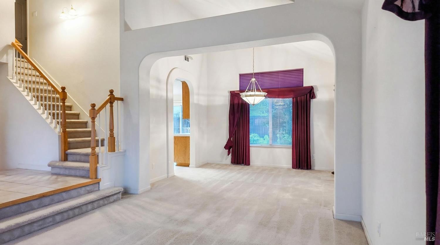 4124 Singletree Way Fairfield, CA 94533 - Photo 9 of 43 a view of a big room with wooden floor and stairs