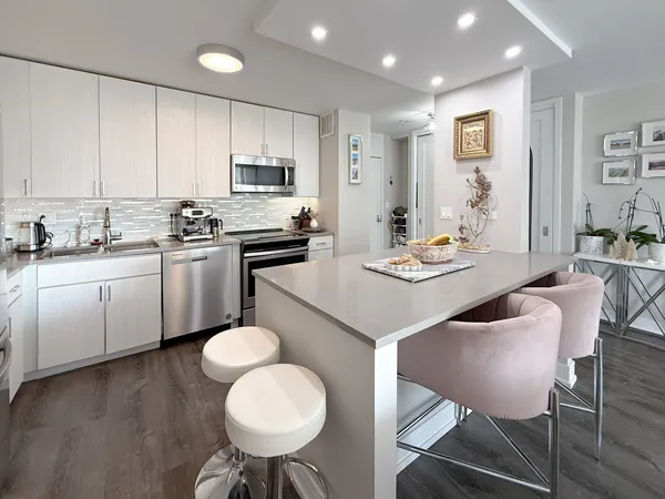 a kitchen with a sink a stove a microwave and cabinets