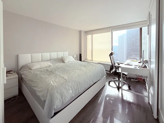 a bed room with a bed and a chair