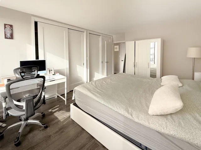 a bedroom with a bed and a table in it