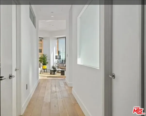 a view of a bedroom with wooden floor