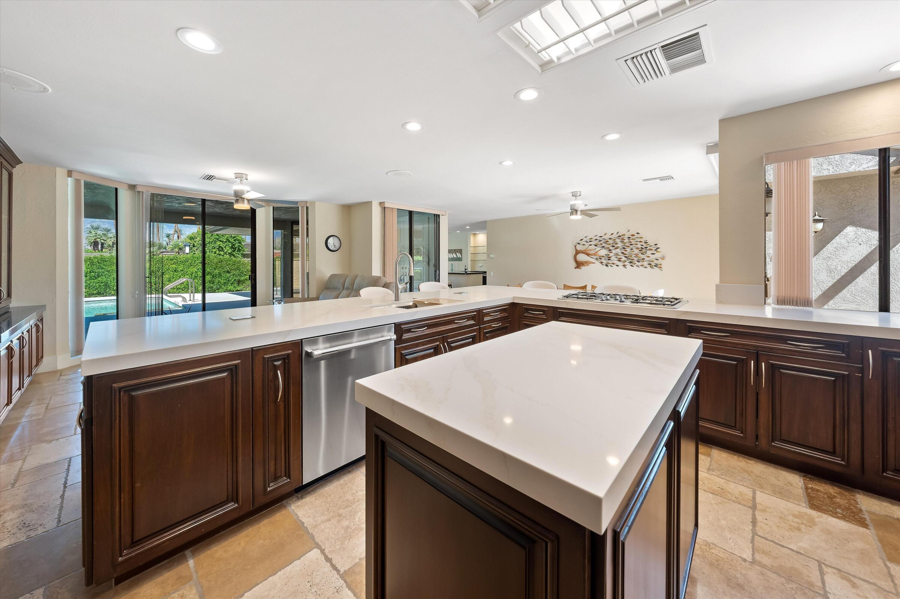 62 Dartmouth Drive Rancho Mirage, CA 92270 - Photo 10 of 46 a kitchen with a stove a sink and a refrigerator