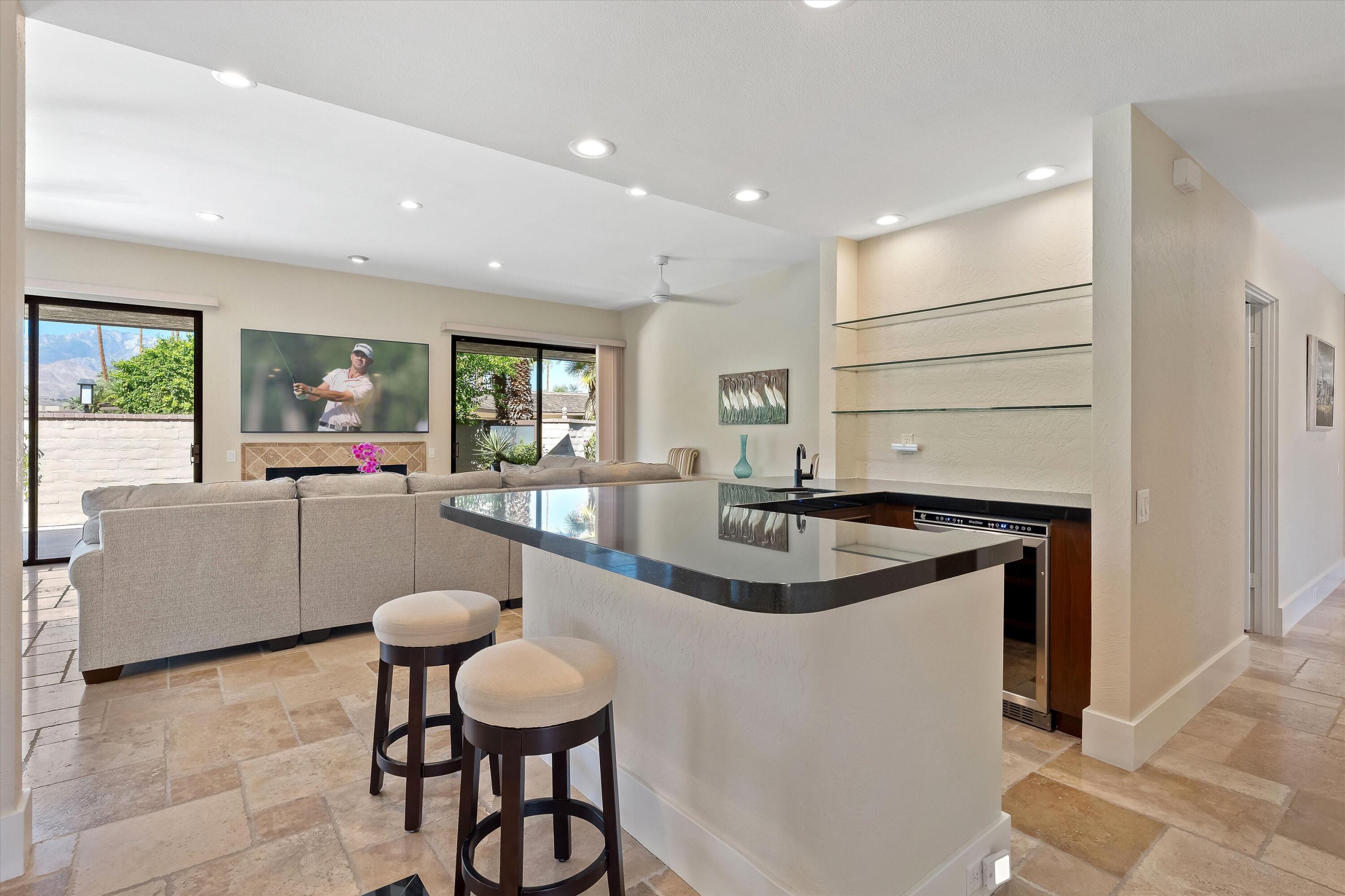 62 Dartmouth Drive Rancho Mirage, CA 92270 - Photo 15 of 46 a kitchen with stainless steel appliances granite countertop a sink and a refrigerator