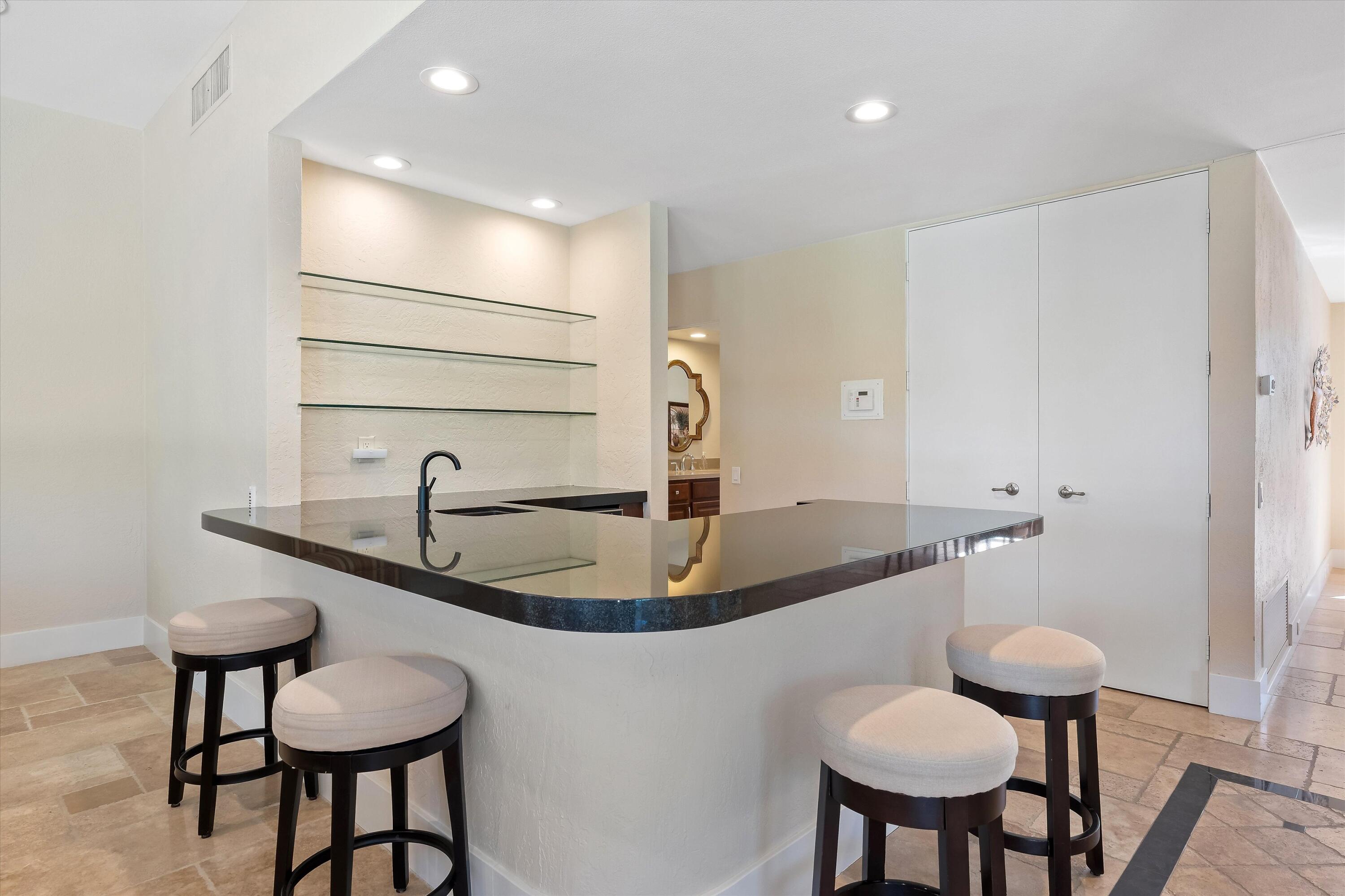 62 Dartmouth Drive Rancho Mirage, CA 92270 - Photo 16 of 46 a bathroom with a granite countertop sink and a mirror